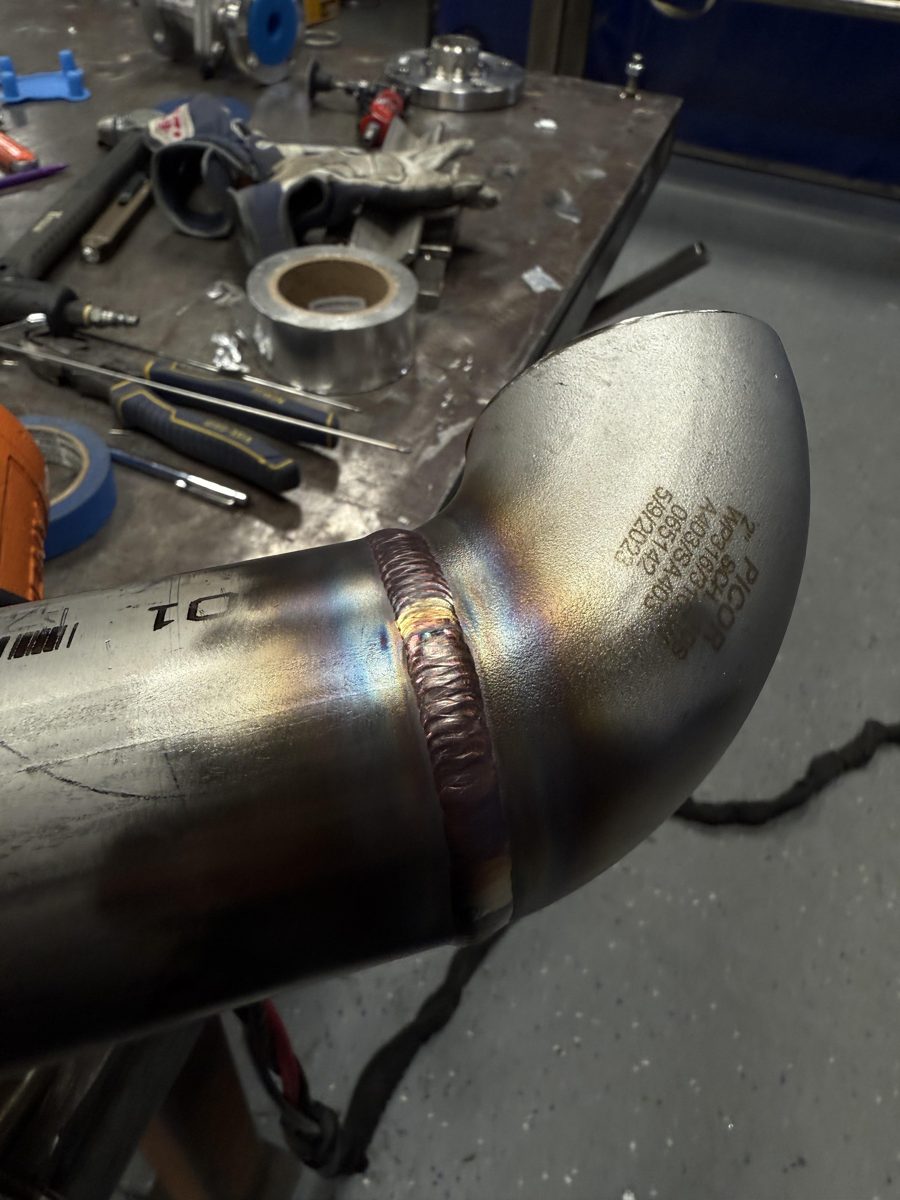 Finished weld on a stainless steel pipe elbow
