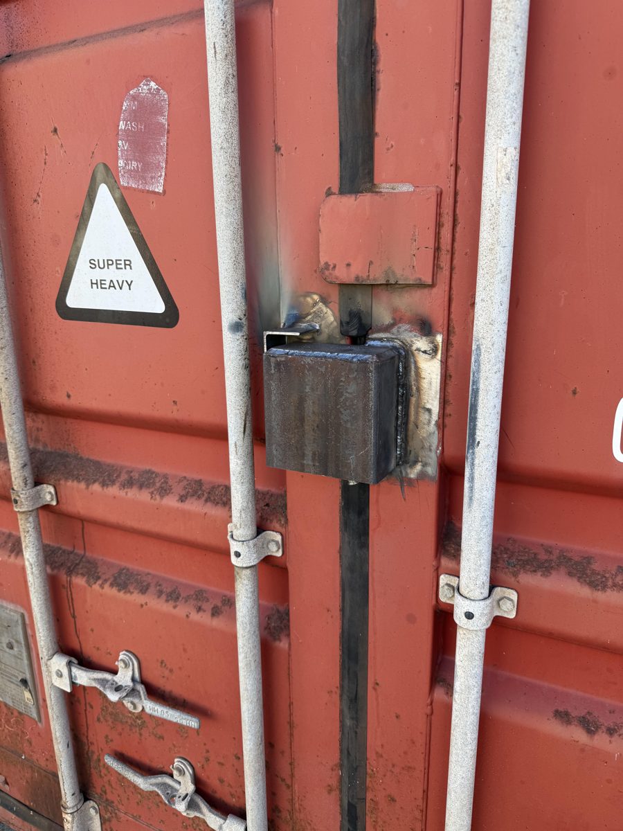 Welded lockbox repair on a shipping container door